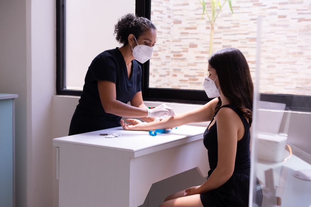 Womens Hair Fall Packages A healthcare professional wearing a face mask performs a blood test on a female patient in a clinic.
