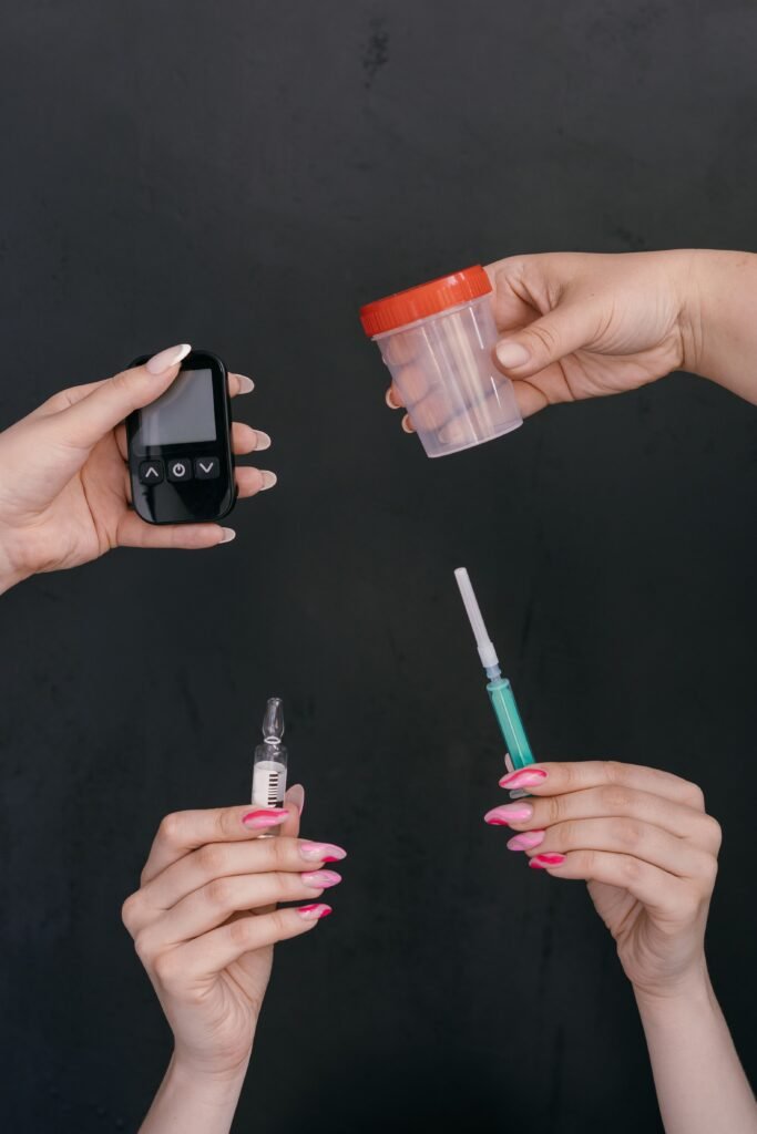 Premium Health Packages (PHP) Hands displaying diabetes management tools including a glucometer, insulin syringe, and container.